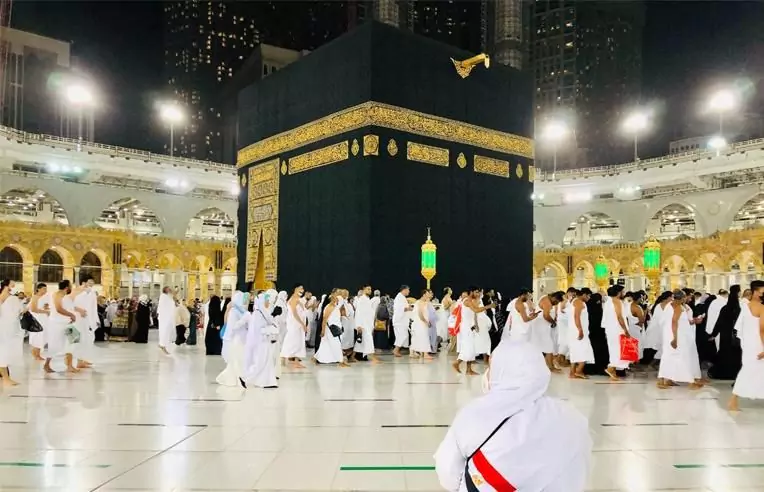 Pilgrims praying at the Kaaba at night